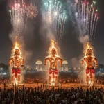 A large crowd watches as three massive effigies of Ravana, Kumbhakarna, and Meghnad burn with fireworks exploding overhead during Dussehra in Delhi