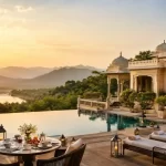 Luxury resort with an infinity pool, elegant outdoor seating, and scenic mountain views, representing the best Weekend Breaks Near Delhi for 2026.