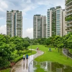 Green park and walking trail among high-rise areas in Delhi with residents jogging and cycling after rain